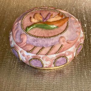 Vintage Oval trinket box with lid beautiful design and on top a flower.